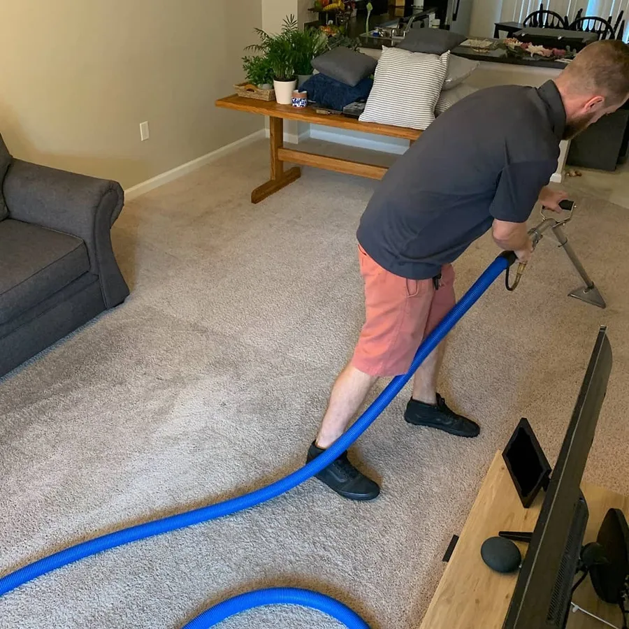 Bryan Wilson cleaning carpet in a Westerville home with truck-mount HWE equipment